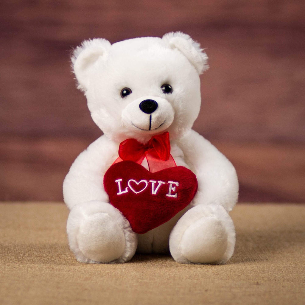 A white bear that is 8 inches tall while sitting holding a red Love heart