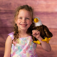 girl holding 9 in stuffed majestic eagle 