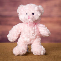 A light pink bear that's 10 inches tall while standing 