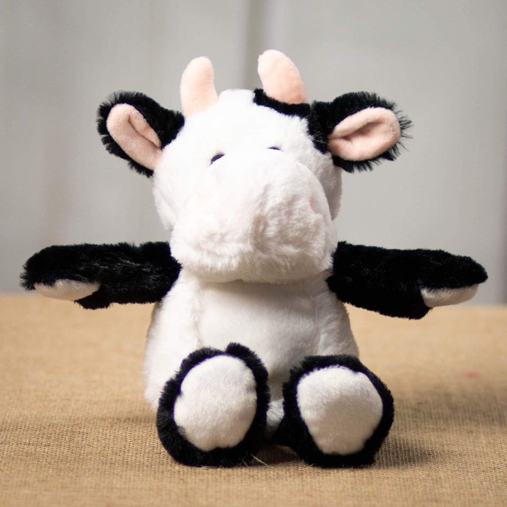 A black and white cow that is 11 inches tall while standing