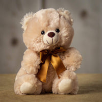 A beige teddy bear that is 9 inches tall while sitting