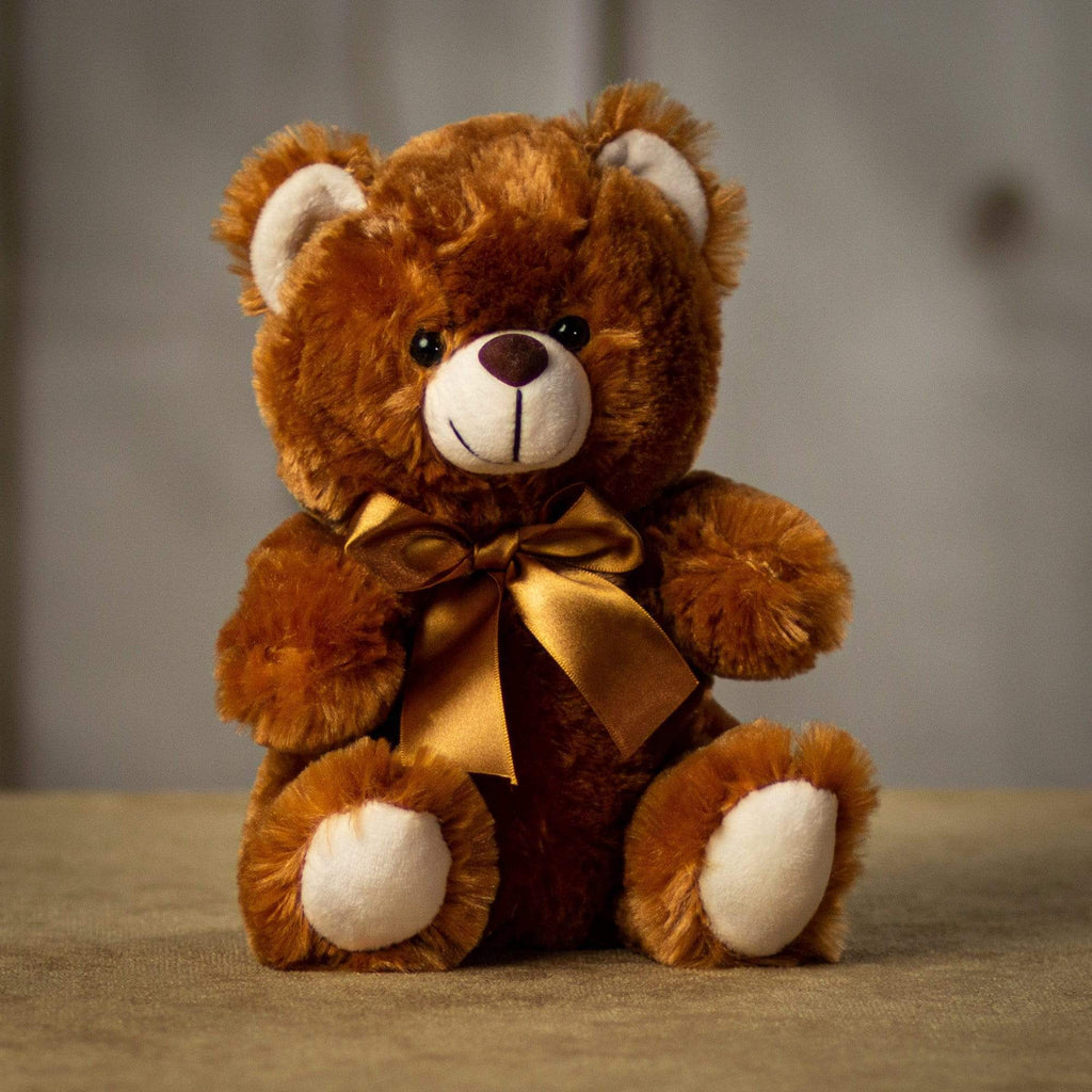 A brown teddy bear that is 9 inches tall while sitting