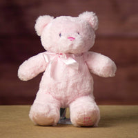 A pink bear that is 10 inches tall while standing with "My First Bear" on its left paw