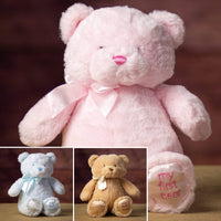 A blue, pink, and beige bear that are 15 inches tall while sitting with "My First Bear" on its left paw