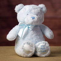 A sitting blue bear that is 15 inches tall while standing with "My First Bear" on its left paw