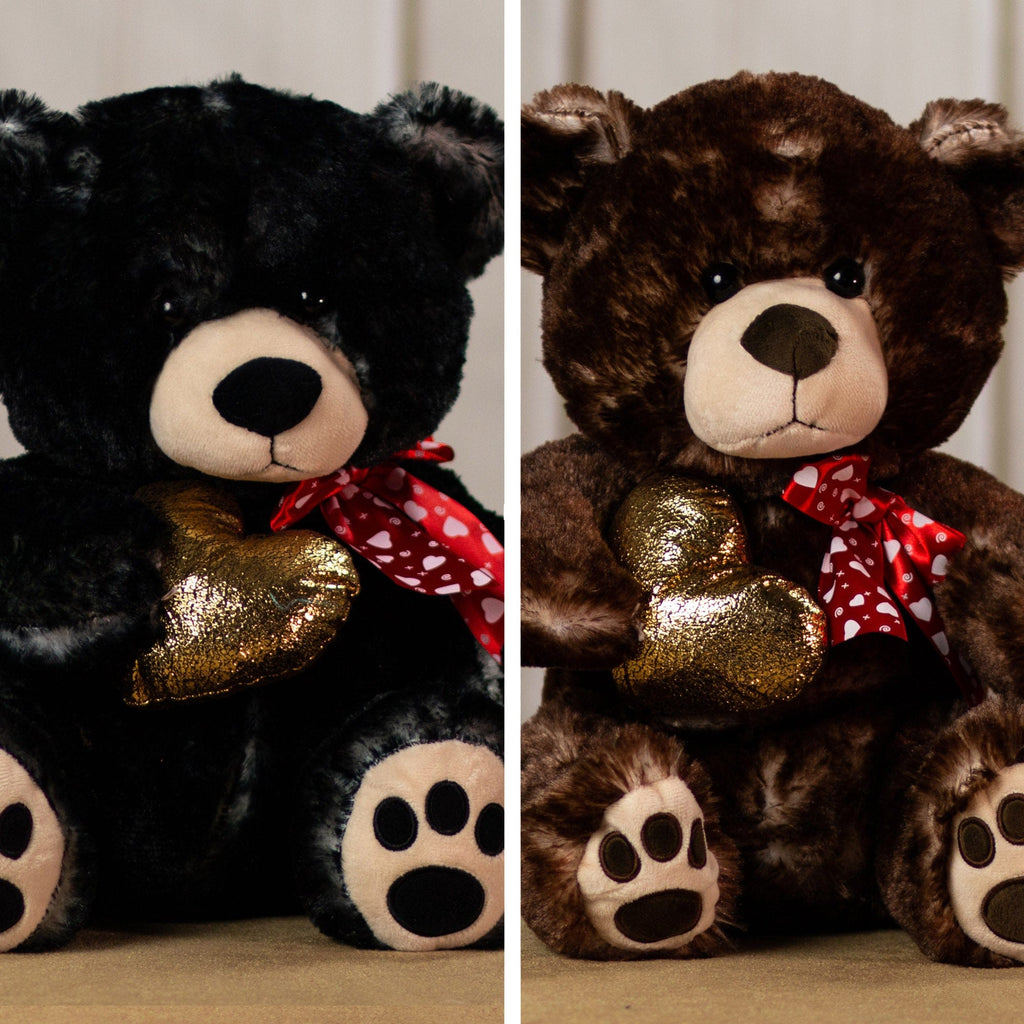 Brown and black bears that are 17 inches tall with paw prints on its feet wearing a red heart covered bow holding a shiny, gold heart