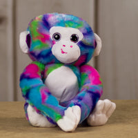 A psychedelic monkey that is 15 inches tall from head to toe with shiny purple ears and sparkle eyes