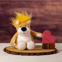 A lion that is standing 13 inches tall from head to toe with a fiery yellow mane next to wooden blocks