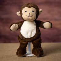 A brown monkey that is 13 inches tall while standing with a white belly