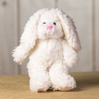 A white scruffy rabbit that is 13 inches tall while standing with corduroy ears and feet