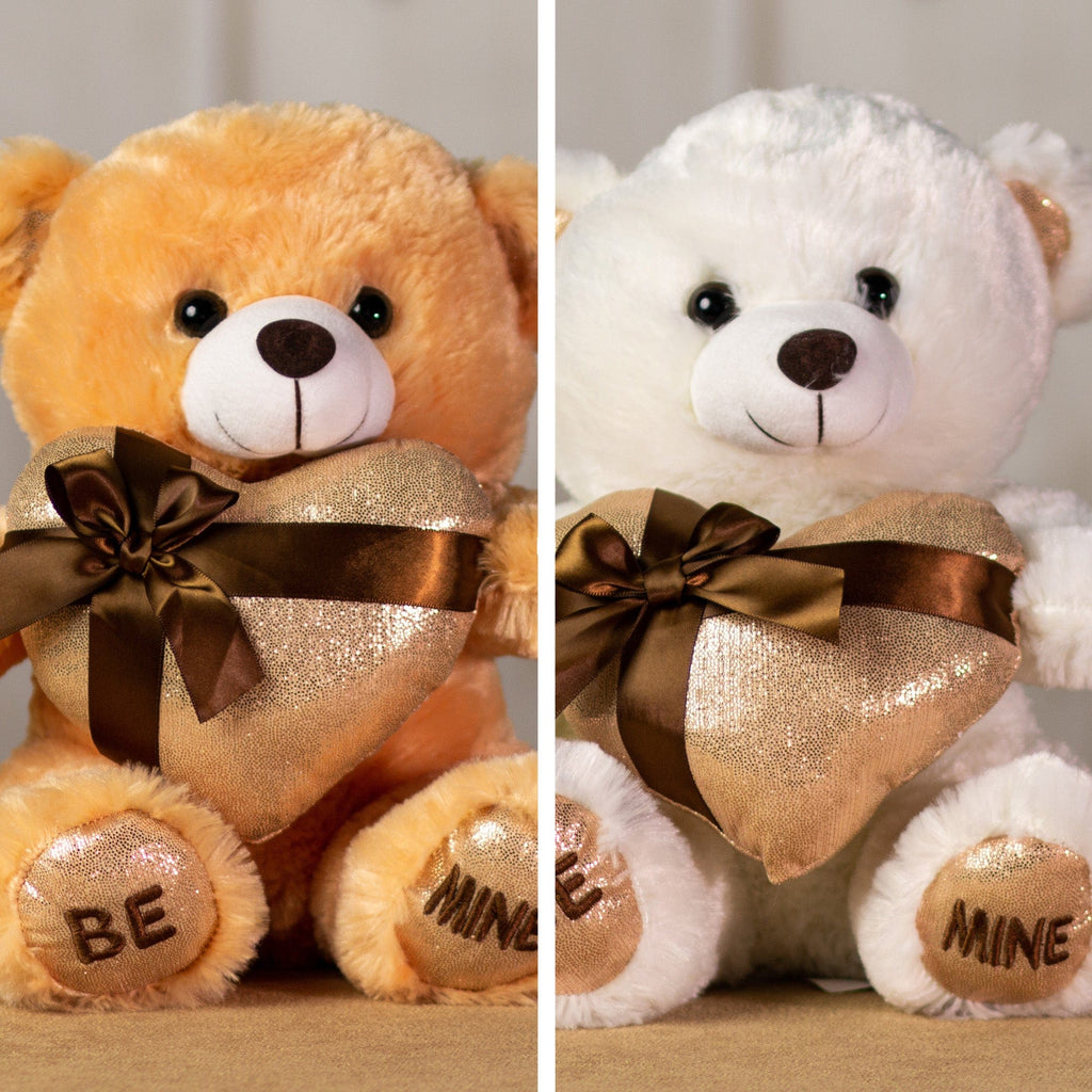 A beige and white bears that are 11 inches tall while sitting holding a shiny gold gift-wrapped heart with BE MINE embroidered on its feet