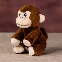 A brown monkey that is 5 inches tall while sitting