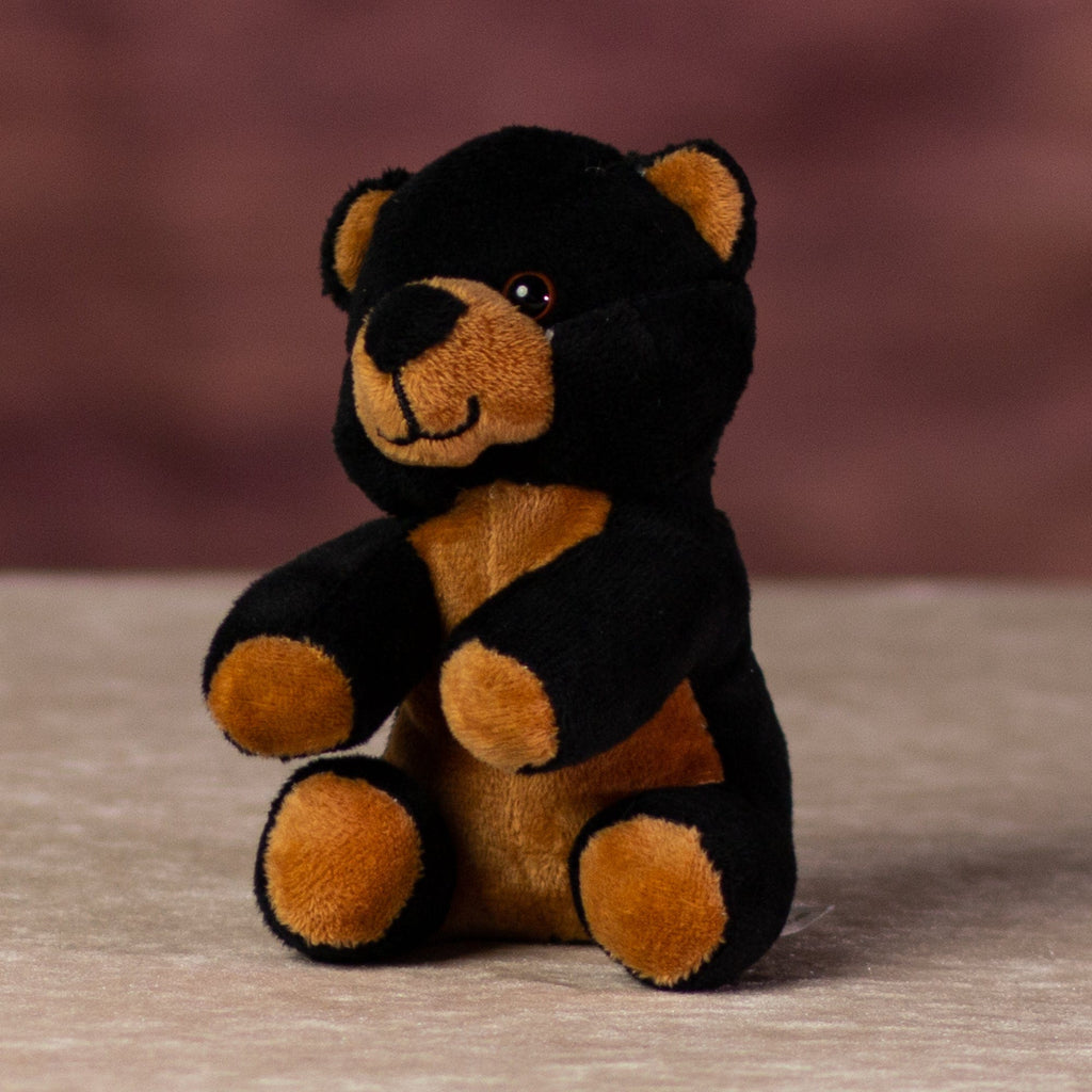 A black and brown bear that is 5 inches tall while sitting