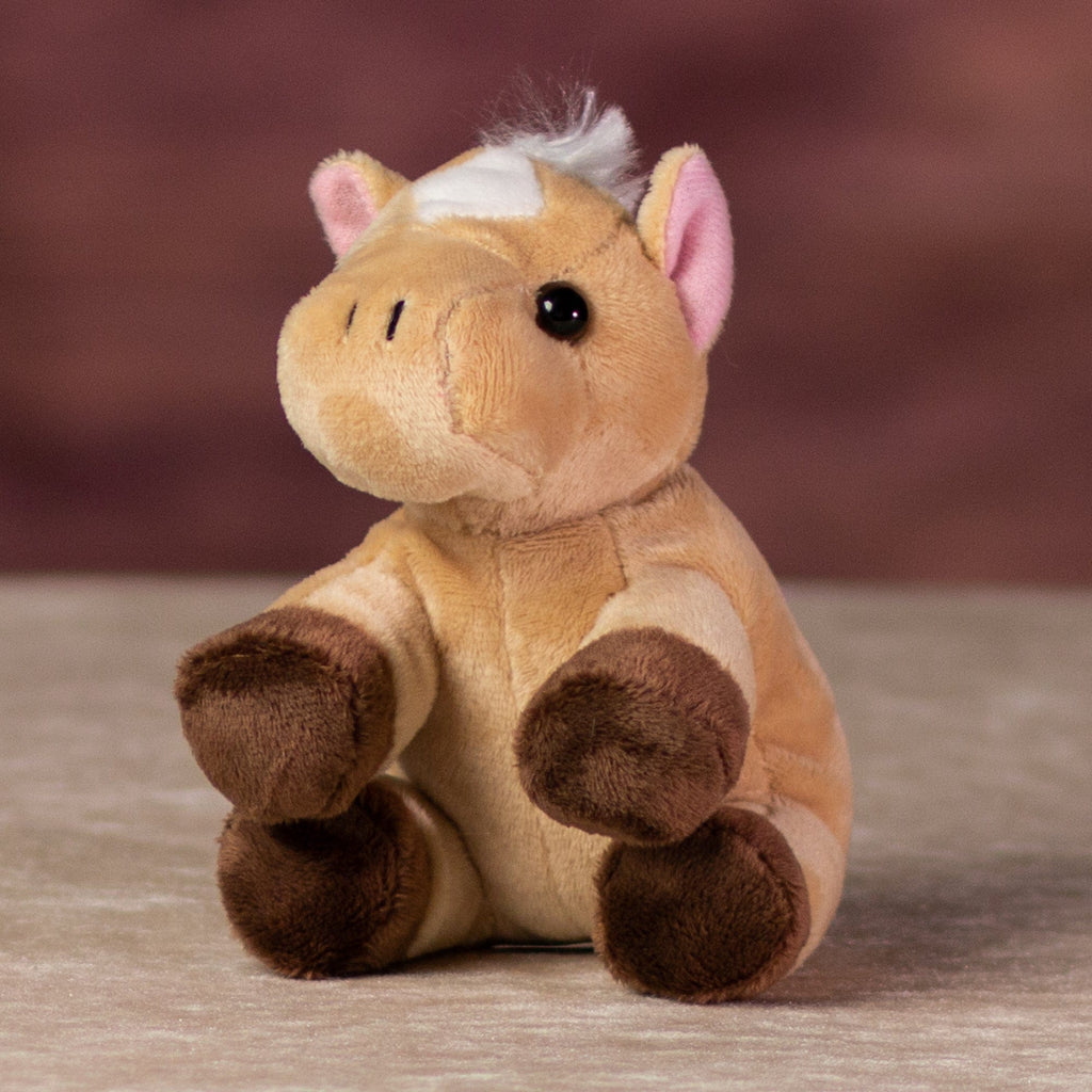 A beige horse that is 5 inches tall while sitting