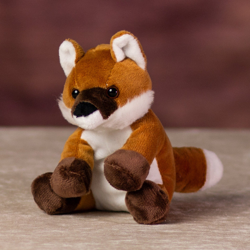 A orange fox that is 5 inches tall while sitting 