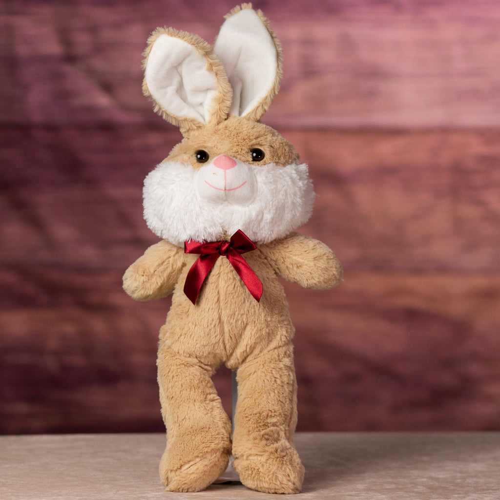 A beige rabbit that is 16 inches while standing wearing a red bow