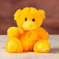 stuffed 6 in yellow bright and cheery bear with bow around her neck