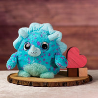 girl holding 8 in stuffed fluffy and spunky blue rhino with sparkle eyes