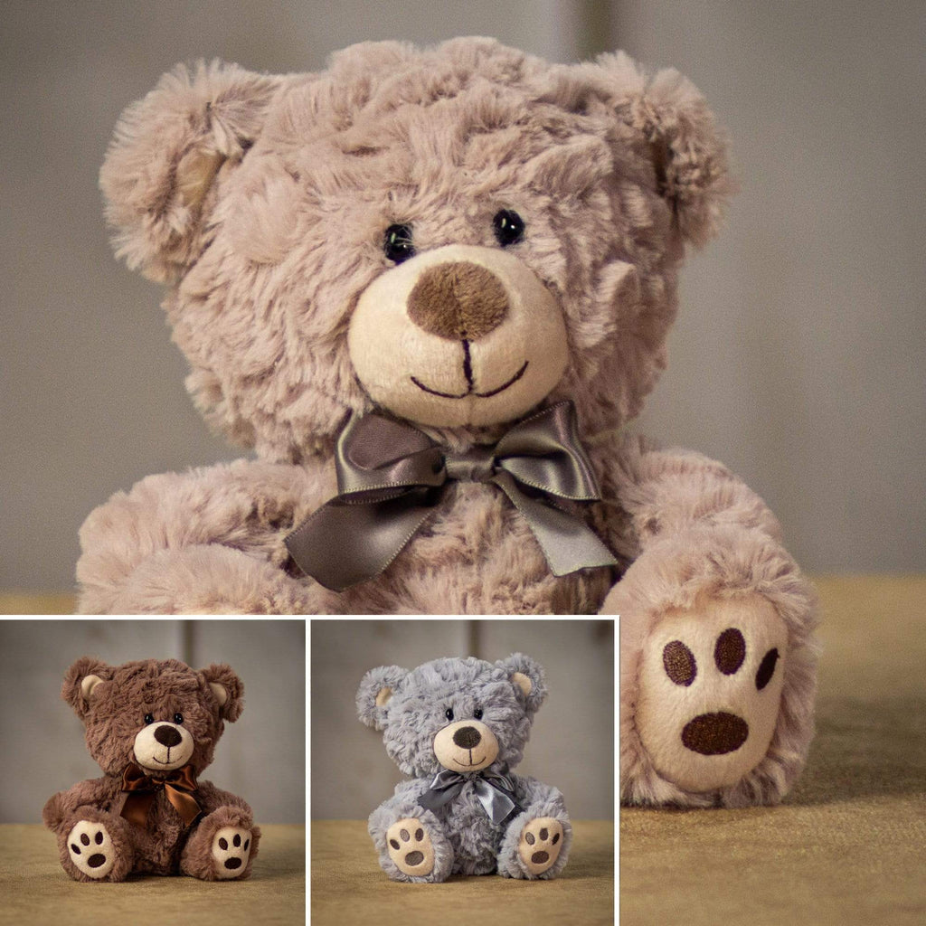 A beige, brown, and gray bear that are 7 inches tall while sitting with paw prints on its feet