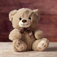 10 in stuffed tan bear wearing a bow