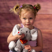 girl holding 9 in stuffed grey valentines elephant with heart