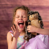 girl holding 9 in stuffed hedgehog