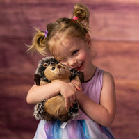 girl holding 9 in stuffed hedgehog