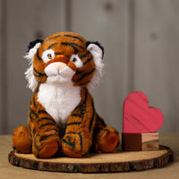 A stripped tiger that is 10 inches tall while sitting on a piece of wood