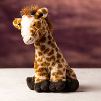 A spotted brown giraffe that is 10 inches tall while standing