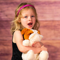 girl holding 10 in stuffed big furry bulldog
