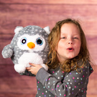 girl holding girl holding 8 in stuffed fluffy and spunky grey owl with sparkle eyes