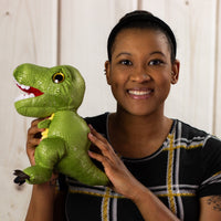 A woman holding a green dinosaur that is 9.5 inches tall while standing