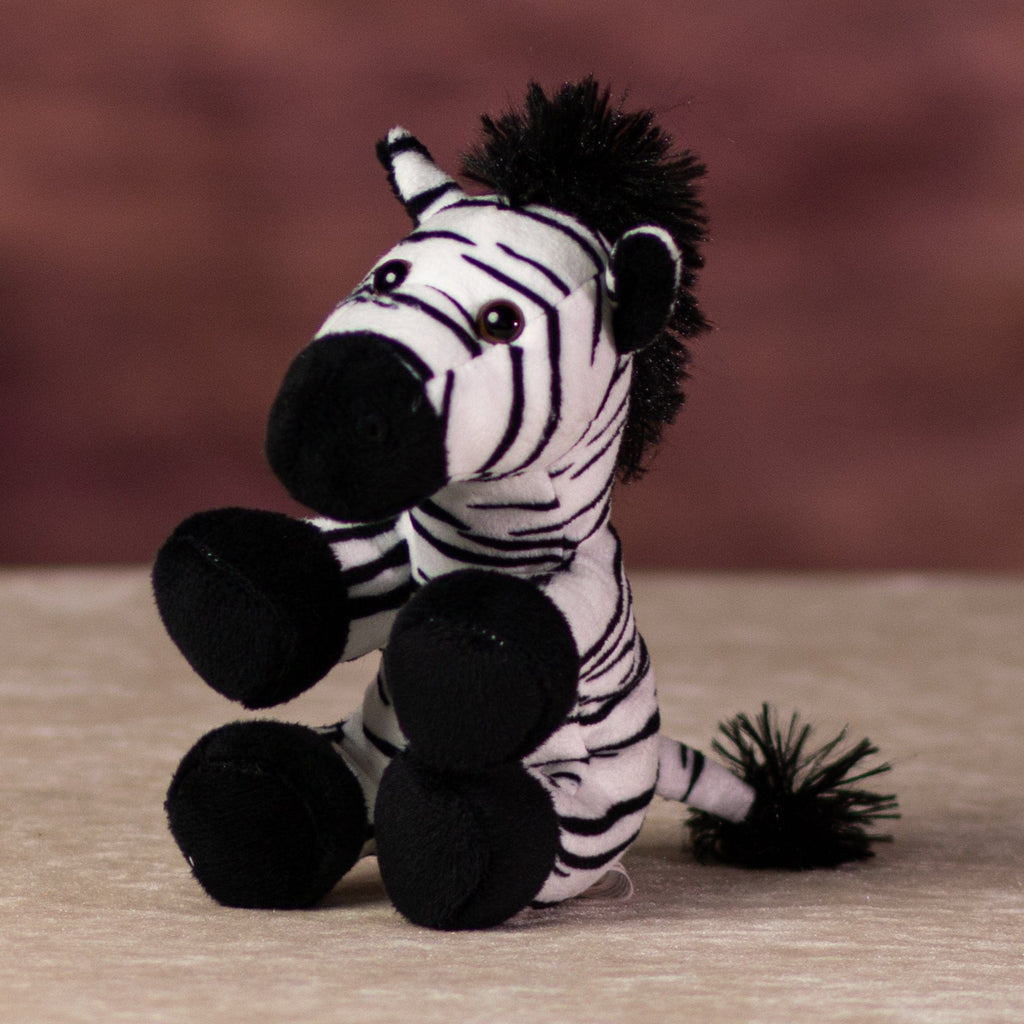A black and white stripped zebra that is 5 inches tall while sitting