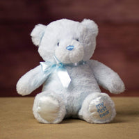 A sitting blue bear that is 10 inches tall while standing with "My First Bear" on its left paw