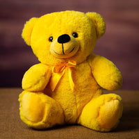 A yellow bear that is 9 inches tall while sitting
