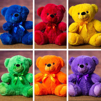 A purple, orange, green, yellow, red, and blue bear that are 9 inches tall while sitting 