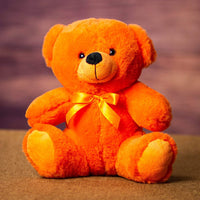 A orange bear that is 9 inches tall while sitting