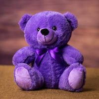 A purple bear that is 9 inches tall while sitting