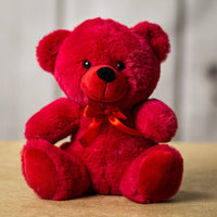 A red bear that is 9 inches tall while sitting