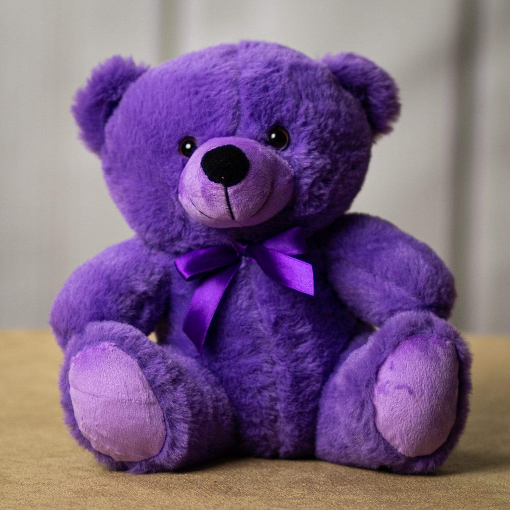 A purple bear that is 9 inches tall while sitting 