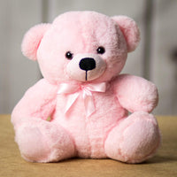 A light pink bear that's 9 inches tall while sitting