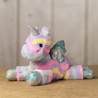 A tie-dye unicorn that is 13 inches while laying down with shiny paws, wings and horn