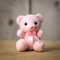 A pink bear that is 6 inches tall while sitting