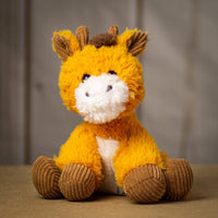 A scruffy giraffe that is 9.5 inches tall while sitting