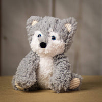 A scruffy gray wolf that is 9.5 inches tall while sitting