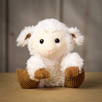 A scruffy white lamb that is 9.5 inches tall while sitting with brown hooves