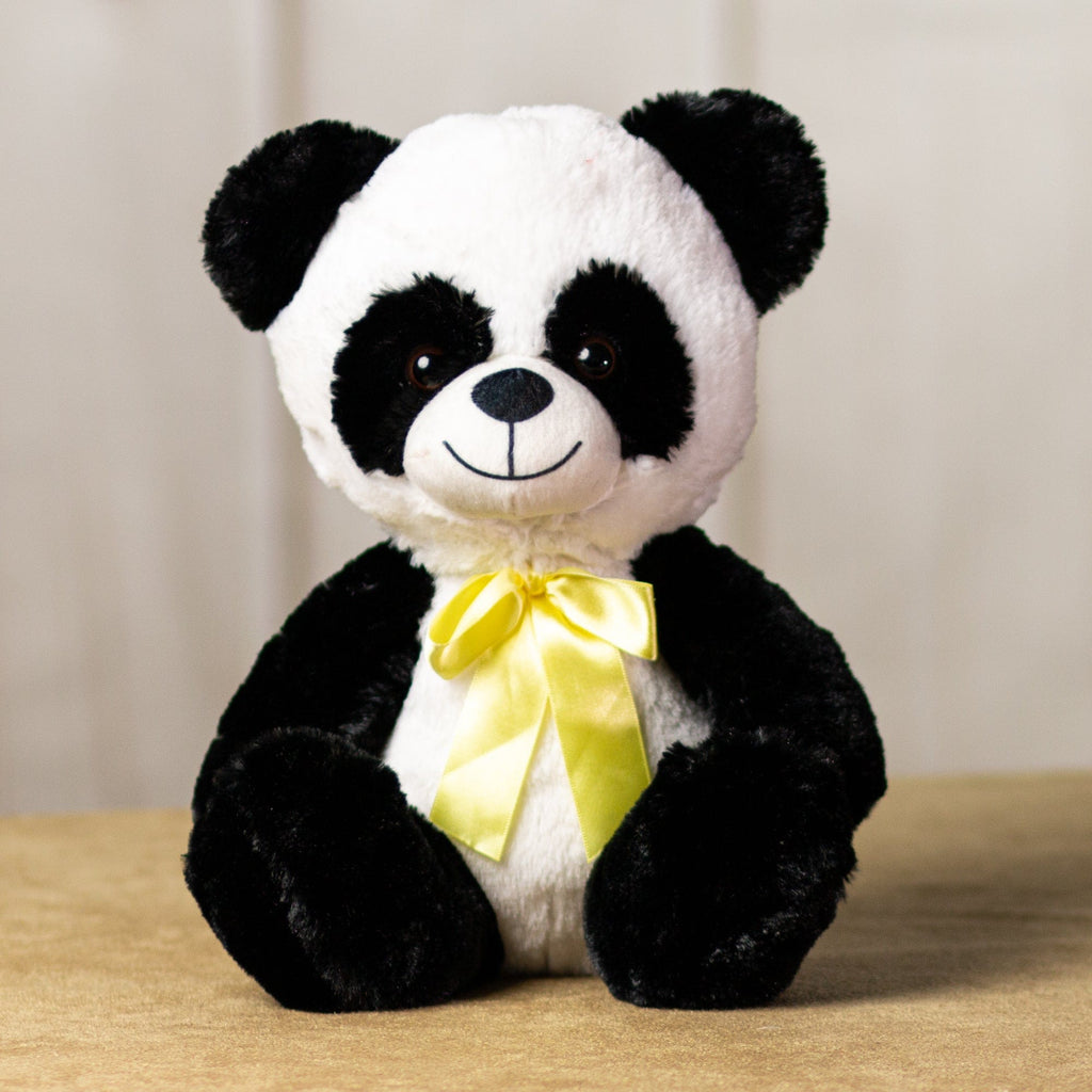 A black and white panda that is 7 inches tall while sitting wearing a yellow bow