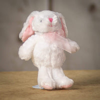 A snow white bunny that is 8 inches tall while standing with pastel pink trims