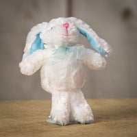 A snow white bunny that is 8 inches tall while standing with pastel blue trims