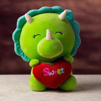 A green dinosaur that is 10.5 inches tall while sitting holding valentine heart